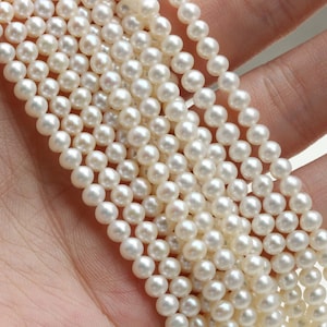 Pode incluir: Um fio de pérolas de água doce brancas, perfeitas para fazer joias. As pérolas são redondas e lisas, com uma cor branca clássica.