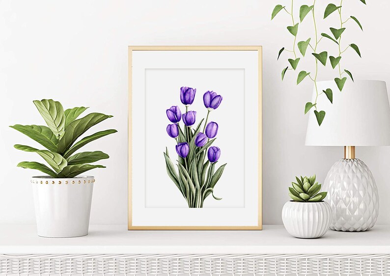 May include: A framed print of a watercolor painting of a bouquet of purple tulips with green leaves.