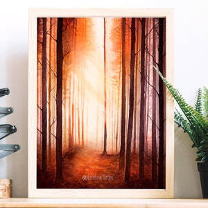 May include: A watercolour painting of a forest path with tall trees on either side. The trees are painted in shades of orange, red, and brown, and the path is illuminated by a bright light in the distance. The painting is framed in a simple wooden frame.