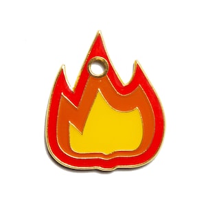 May include: A gold-colored metal charm shaped like a flame. The flame is red, orange, and yellow. The charm has a small hole at the top for attaching it to a keychain or other item.