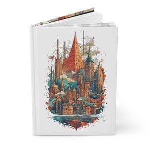 May include: A white notebook featuring a colourful illustration of a city skyline with tall buildings and spires. The illustration is in a watercolour style with splashes of colour.