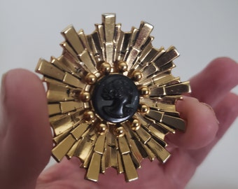 Vintage Coro Gold Tone Flower or Starburst Brooch With Black Resin Cameo Center