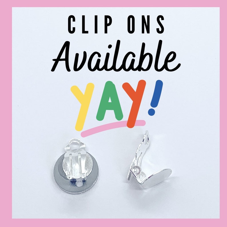 May include: Two silver clip-on earring backs. The text "CLIP ONS Available yay!" is written in colorful letters above the earring backs.