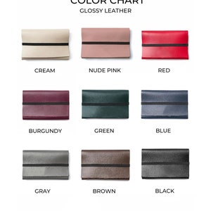 May include: Color chart showing nine different colors of glossy leather wallets. The colors are cream, nude pink, red, burgundy, green, blue, gray, brown, and black.
