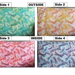 May include: Four sides of a pillow with a dragonfly pattern. The outside is a yellow pillow with orange dragonflies. The inside is a blue pillow with purple dragonflies. The other two sides are a green pillow with teal dragonflies and a pink pillow with red dragonflies.