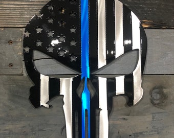 May include: A metal skull silhouette with a black and white American flag design and a blue line down the center.