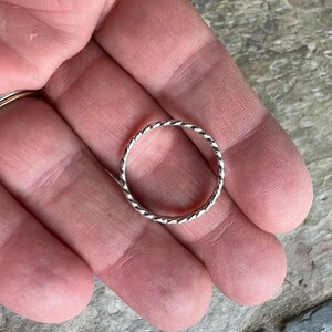 Flattened twist stacking ring
