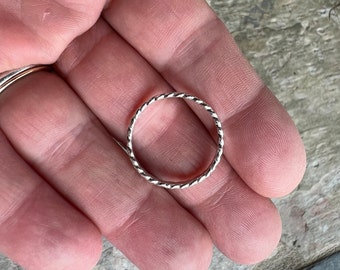 Flattened twist stacking ring