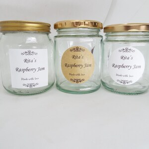 May include: Three glass jars with gold lids and labels that say "Rita's Raspberry Jam" and "Made with love".