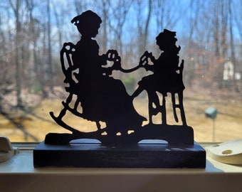 Vintage Hand Cut Wooden Silhouette on Base Woman in Rocking Chair Winding and Young Girl Holding Yarn