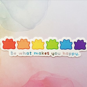 Puede incluir: Una colorida pegatina con seis personajes de dibujos animados en colores del arcoíris: rojo, naranja, amarillo, verde, azul y morado. El texto "Be what makes you happy" está debajo. La pegatina tiene un borde blanco.
