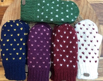May include: Five pairs of knitted mittens with heart patterns. The mittens are in various colours, including green, blue, purple, red, and white.