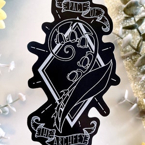 May include: Black and white sticker with a stylized illustration of a lily of the valley flower with the text "Pact of the Archfey" in a banner.