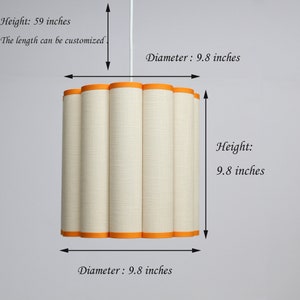 May include: A cylindrical lampshade with a cream-colored fabric and orange trim. The lampshade has a height of 59 inches and a diameter of 9.8 inches. The length can be customized.