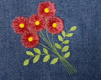 May include: Embroidered red flowers with yellow centers and green leaves on a blue denim background.