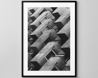 May include: Black and white photograph of a building with a unique geometric design. The building has many balconies and windows, creating a pattern of overlapping squares.