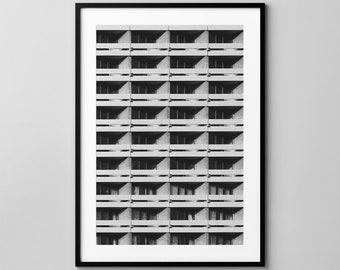 May include: Black and white framed print of a building facade. The image shows a repeating pattern of balconies and windows, creating a grid-like composition. The architectural photograph is a study in light and shadow.