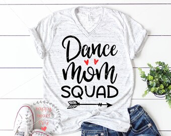 May include: White t-shirt with the text "Dance Mom Squad" in black with two red hearts above the word "Mom" and a black arrow pointing to the right.