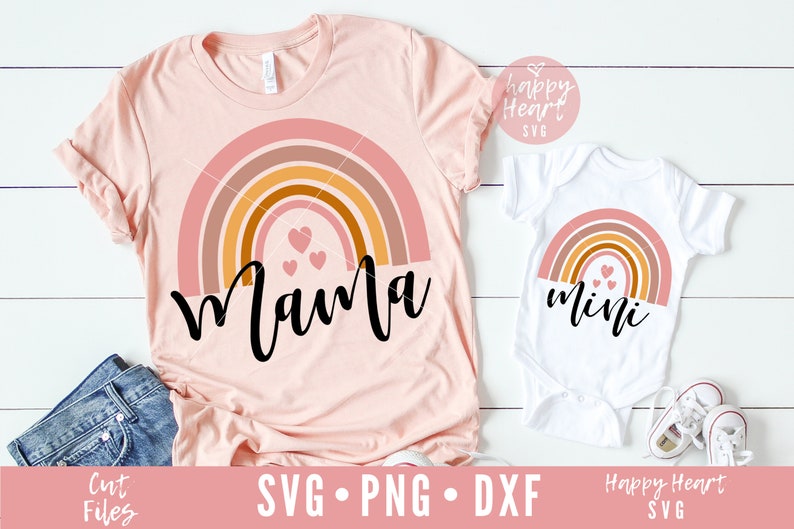 May include: A set of two shirts featuring a rainbow with hearts and the words "mama" and "mini". The shirts are pink and white.