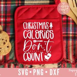 May include: Red oven mitt with white text that reads "Christmas Calories Don't Count" with a small Christmas tree, a whisk, and a mitten graphic.