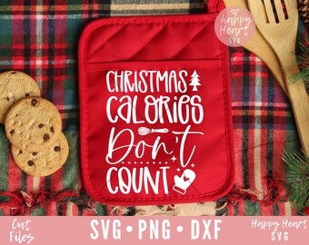 May include: Red oven mitt with white text that reads "Christmas Calories Don't Count" with a small Christmas tree, a whisk, and a mitten graphic.