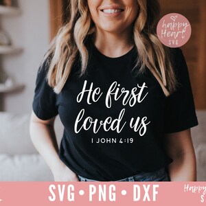 May include: A black t-shirt with white text that reads "He first loved us I John 4:19".