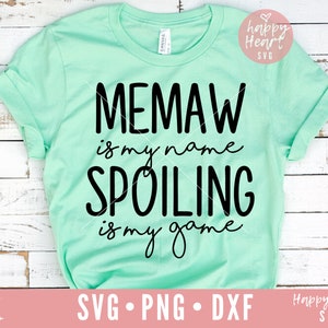 May include: A light green t-shirt with black text that reads "MEMAW is my name SPOILING is my game".