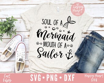 May include: A white t-shirt with black text that reads "Soul of a Mermaid Mouth of a Sailor" with a mermaid tail and anchor graphic.