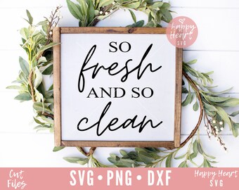 May include: A wooden sign with the text "So fresh and so clean" in black script font. The sign is surrounded by greenery.