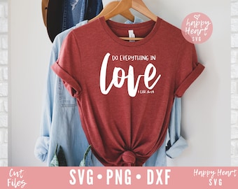 May include: A red t-shirt with the text "DO EVERYTHING IN love 1 COR. 16:14" in white lettering. The shirt is hanging on a wooden hanger.