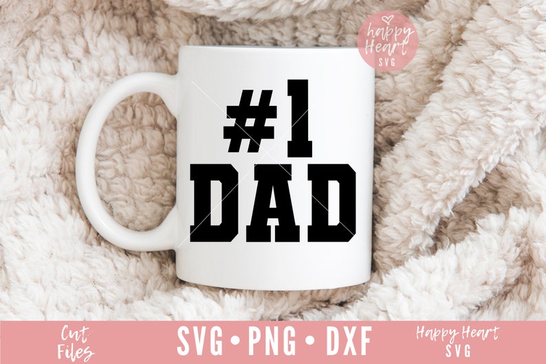 K&ouml;nnte beinhalten: Eine wei&szlig;e Keramiktasse mit einer schwarzen Grafik, auf der in fetter Schrift "#1 DAD" steht.