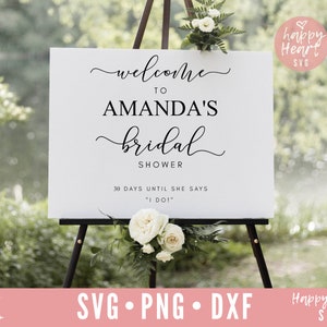 May include: White sign with black text that reads "Welcome to Amanda's Bridal Shower 30 Days Until She Says "I Do!" "
