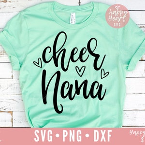 May include: A light green t-shirt with the text "cheer mama" in black script lettering. There are small hearts around the text.