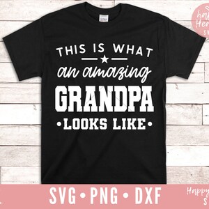 Op de afbeelding: Zwart T-shirt met witte tekst die luidt: "Dit is hoe een geweldige opa eruitziet."