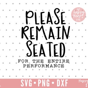 May include: Black and white text on a white background with a pink heart graphic. The text reads "Please Remain Seated For The Entire Performance".