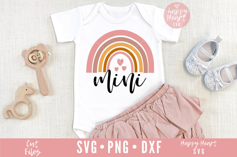 May include: A white onesie with a rainbow design and the word "mini" in black script. There are three small pink hearts in the center of the rainbow.