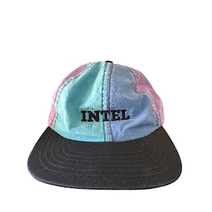 May include: A black, blue, and purple baseball cap with a black bill and the word "INTEL" embroidered in black on the front.