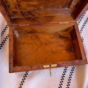 Detailed shot of the thuya wooden box's inside storage space, showcasing the wood burl grain and spacious storing room for keepsakes