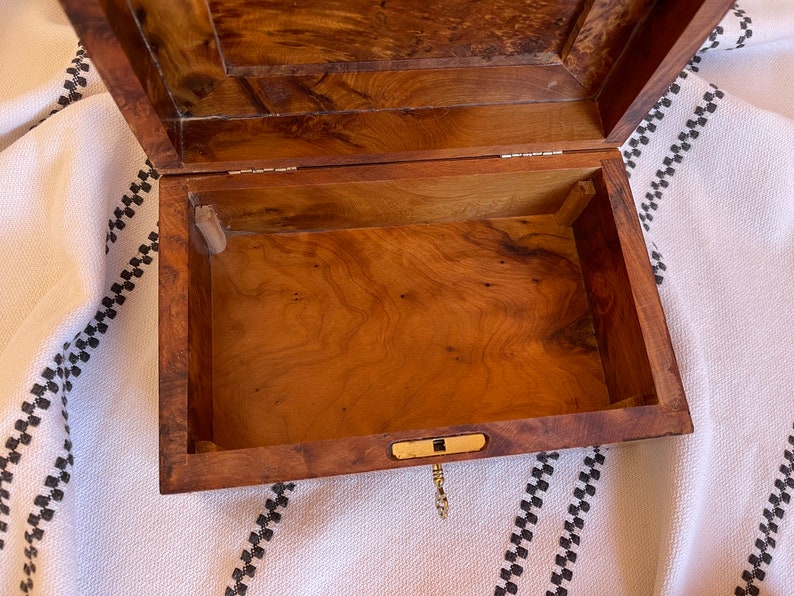 Detailed shot of the thuya wooden box's inside storage space, showcasing the wood burl grain and spacious storing room for keepsakes