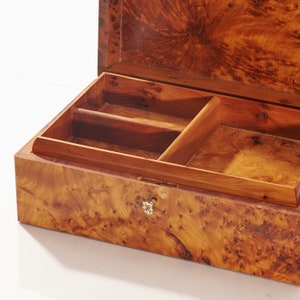 close shot on thuya wooden box to show burl grain patterns, the pictures shows brass key inserted in the box lock