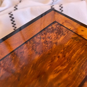 Close-up of the brass lock and key on a Moroccan thuya wooden box with burl wood accents