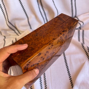 thuya wooden box held by hand