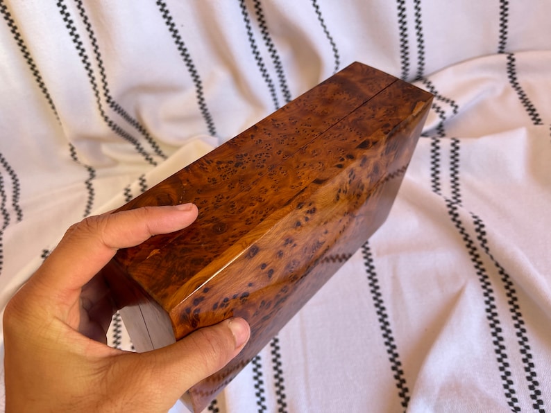 thuya wooden box held by hand