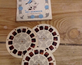 Carrete View-Master antiguo con folleto de Disney: La hamaca aérea del Pato Donald
