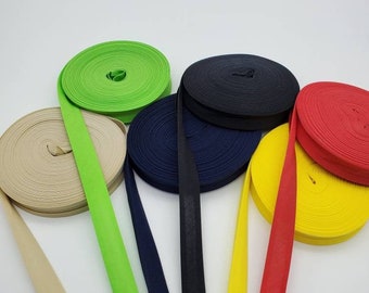 May include: Six spools of fabric trim in various colors, including beige, green, navy blue, yellow, and red. The spools are arranged in a fan shape.