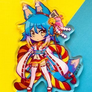 May include: A colorful anime-style character keychain with blue hair, a red and yellow striped tail, and a white and blue outfit. The character is holding a red and white striped stick with a bell and a pink and white object on top. The keychain is made of clear acrylic and has a silver metal ring.