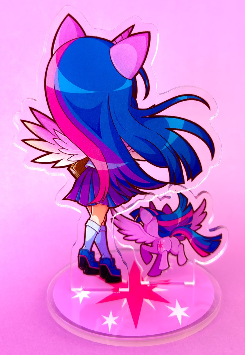 May include: A pink and blue anime-style character with wings and a unicorn horn. The character is wearing a purple and black school uniform and is standing on a pink base with white stars. The character is holding a book in their hand. A smaller version of the character is standing behind the larger character.