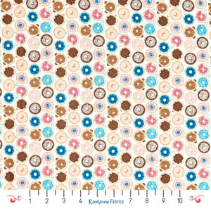 May include: White fabric with a repeating pattern of colorful donuts. The donuts are in various colors, including pink, blue, brown, and white. Some donuts have sprinkles, while others have chocolate frosting. The fabric is perfect for quilting, sewing, and crafting.