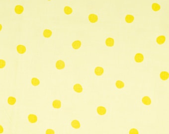 May include: Yellow polka dots on a pale yellow background. The fabric is measured in inches.