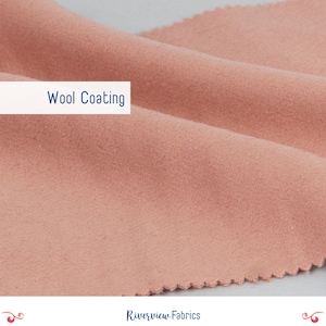 May include: Close-up of a soft, peach-colored fabric with a textured surface. The fabric is labeled "Wool Coating" and is a sample from Riverview Fabrics.